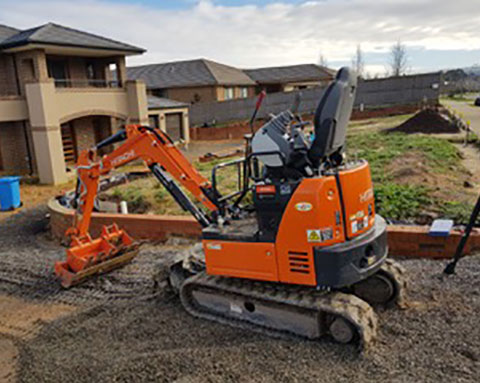 Mini excavator hire in action in Philips island.